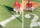 Darian Houston (left) and Brayden Daughtry are pictured near their uniform numbers, which were painted on the Marshall Academy field by head coach Bruce Branch.